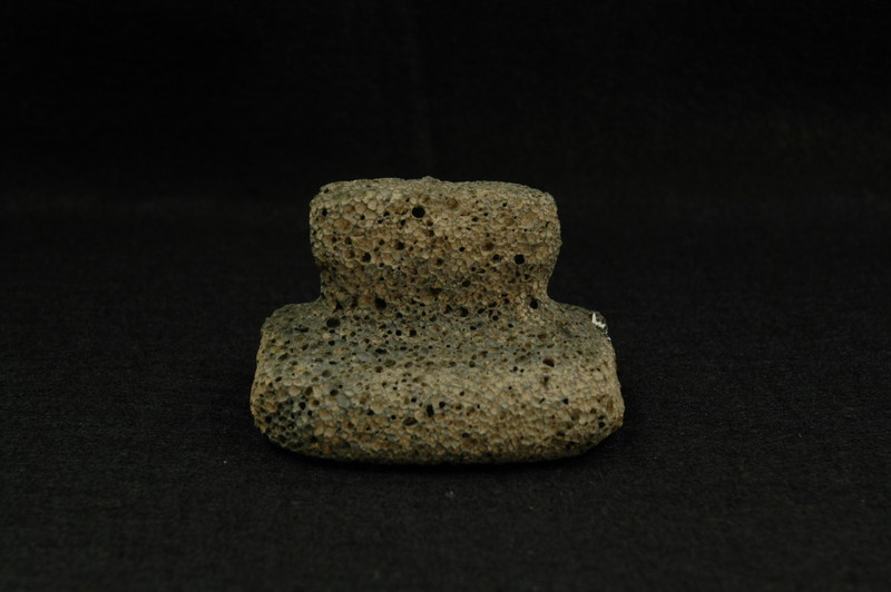 Volcanic pumice stone carved to yield a handle and flat smoothing or beating surface